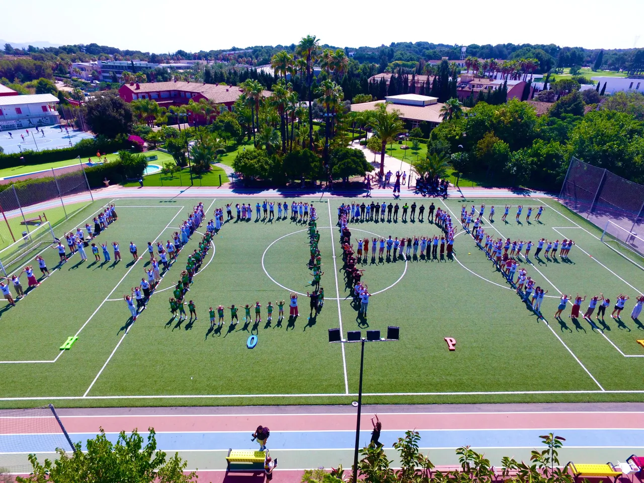 Students spelling out the letters of HOPE on a school field
